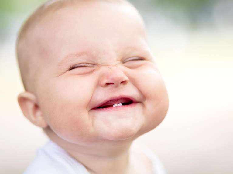 a baby smiling brightly