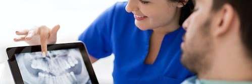dentist showing patient their x-ray during a dental emergency in mount waverley
